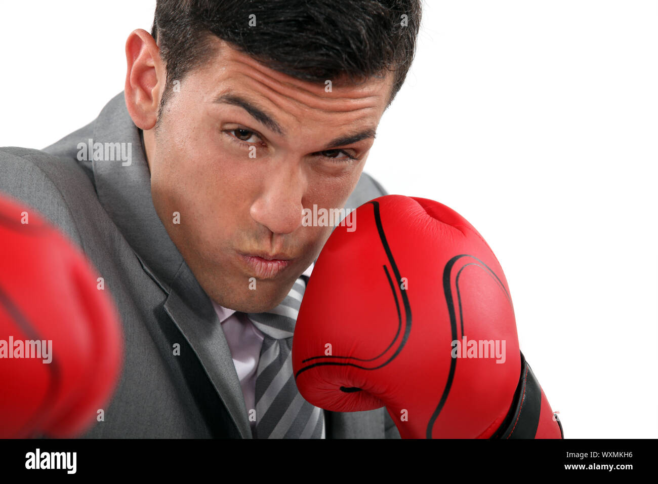 Businessman throwing punches Stock Photo Alamy