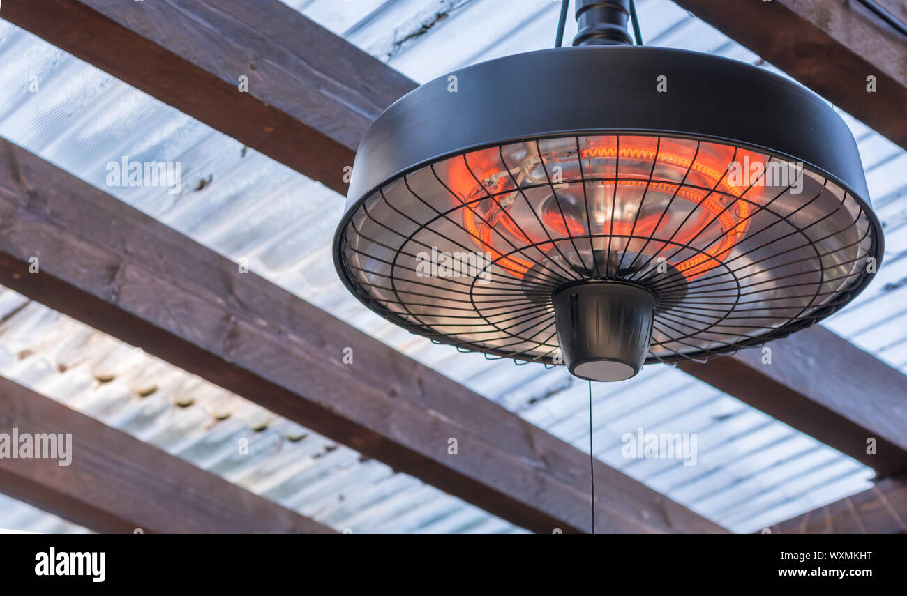 Radiant heater on the ceiling of a terrace roofing Stock Photo