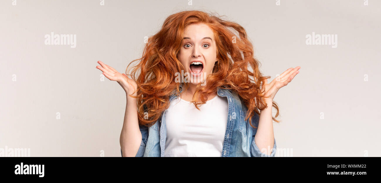 Overjoyed teen girl with flying hair and opened mouth Stock Photo