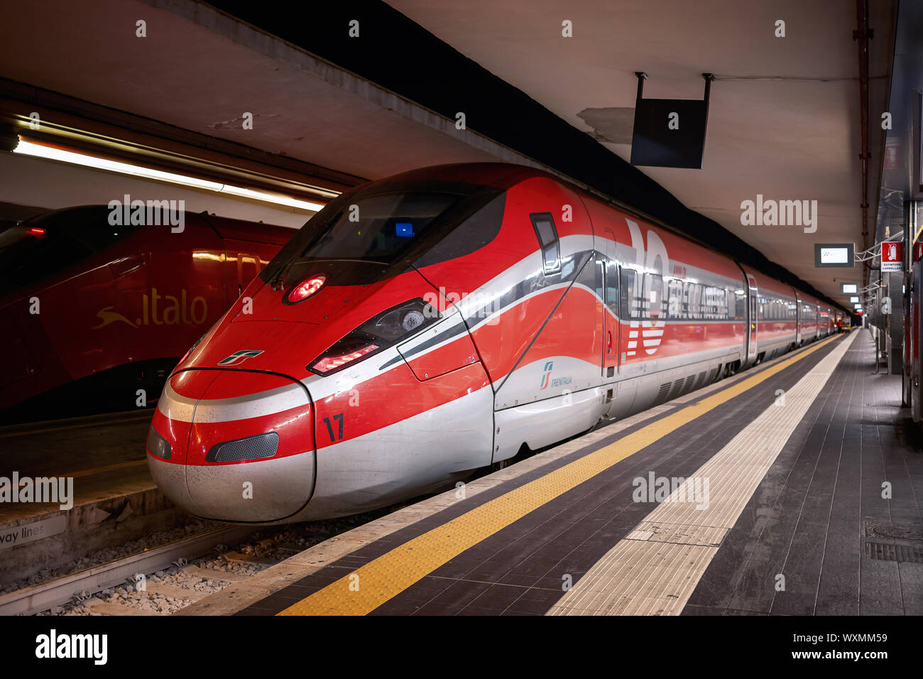 Naples, Italy - September 07, 2019: two high-speed trains of different transport companies, stopped on the platform of the central railway station. Stock Photo
