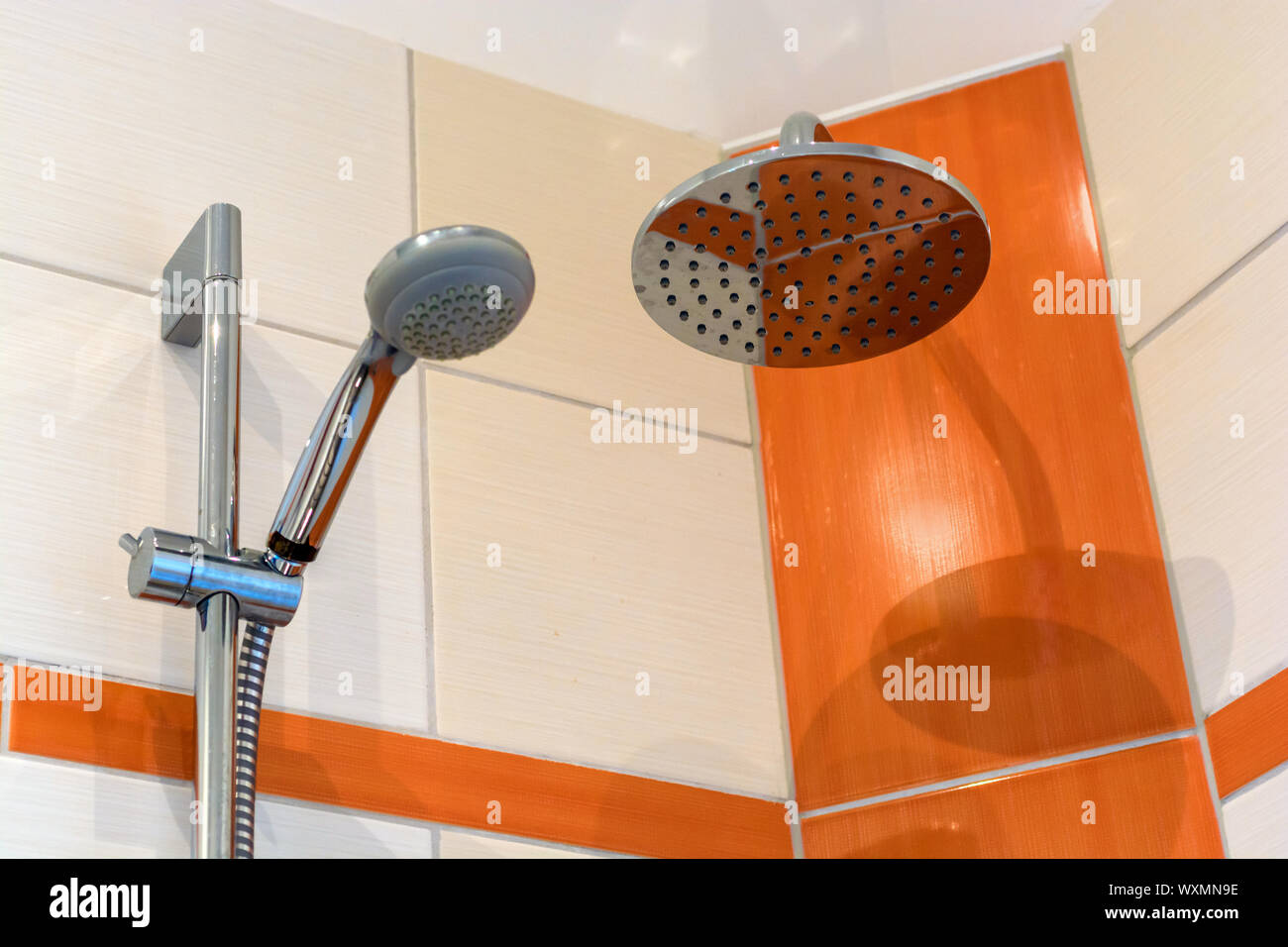 Shower with two shower heads and modern tile mirror Stock Photo Alamy