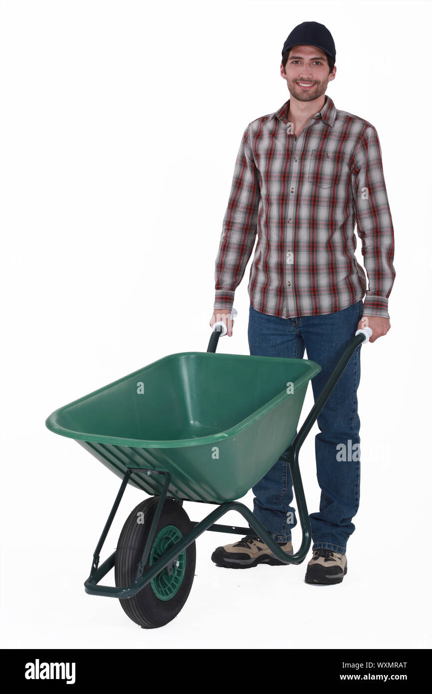 Person pushing red wheelbarrow Cut Out Stock Images & Pictures Alamy