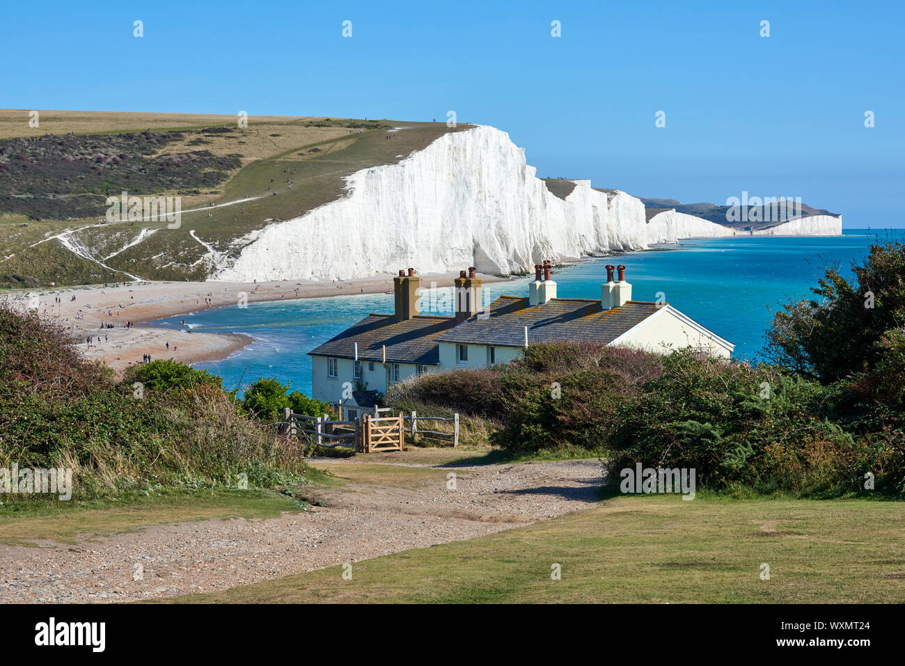Seaford Head, near Eastbourne, East Sussex UK, looking east towards Seven Sisters, with coastguard cottages in foreground Stock Photo