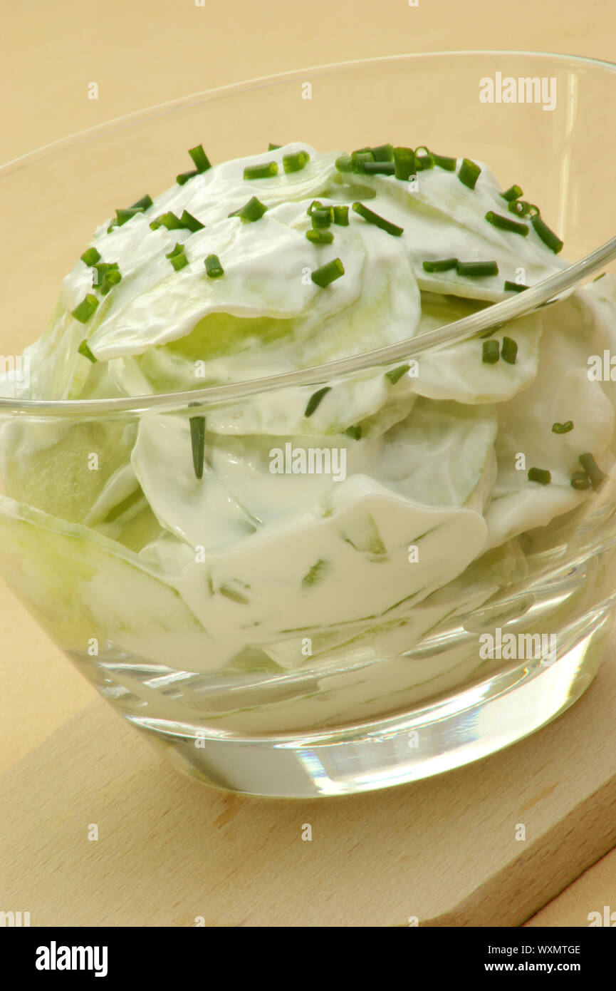 organic cucumber salad in a glass bowl Stock Photo - Alamy