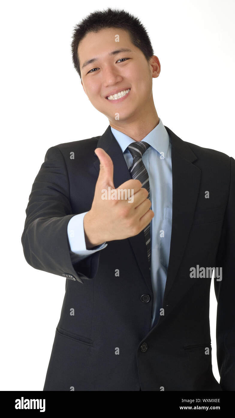 Smiling young business man of Asian giving you a thumbs up sign ...