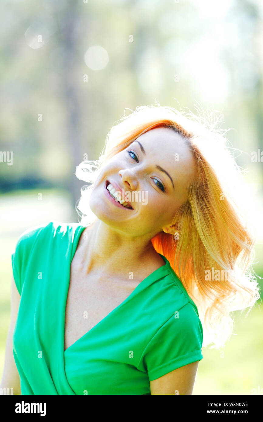 Happy beautiful young woman in park Stock Photo - Alamy