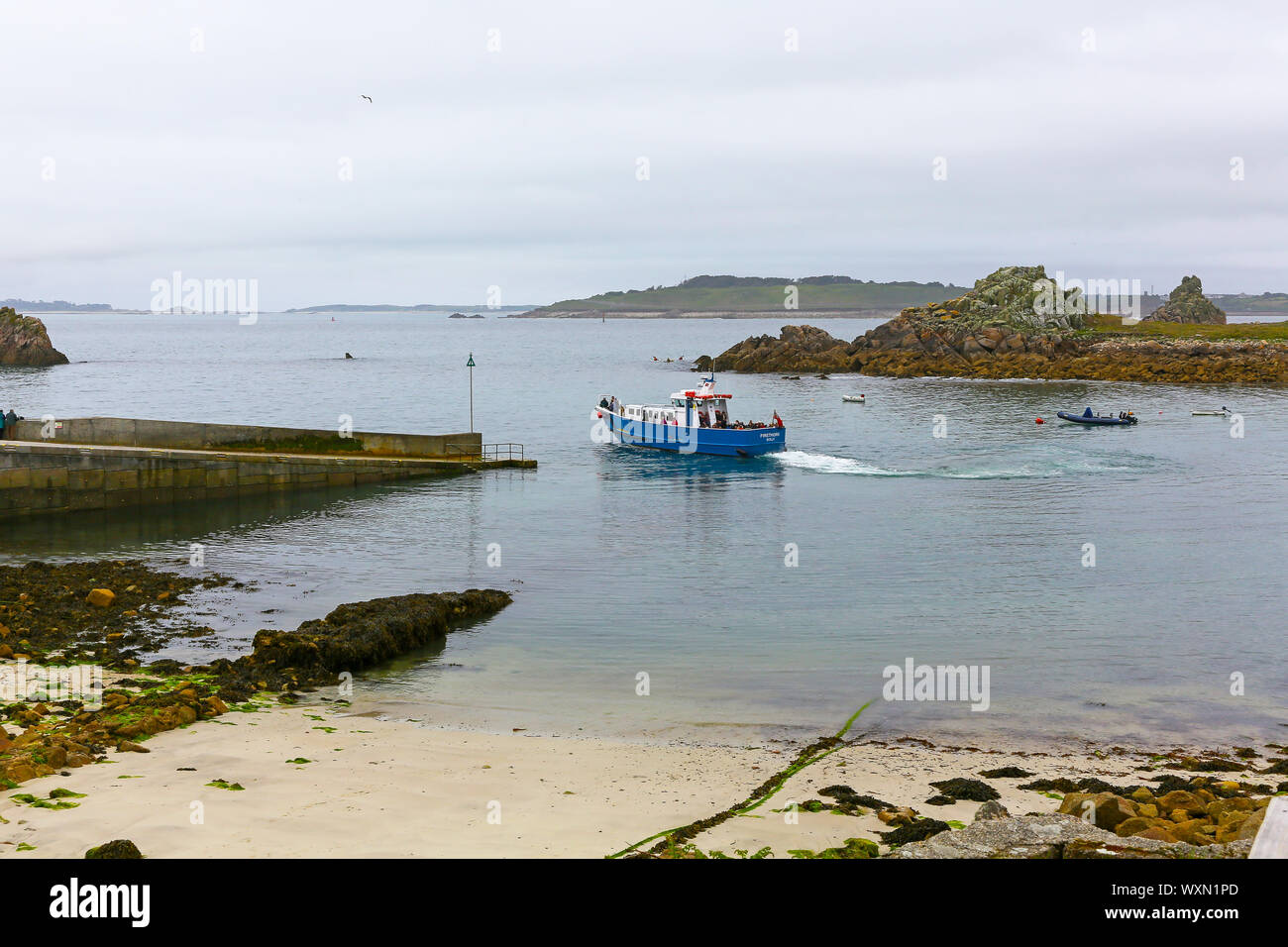A boat called Firethorn departing the quay carrying tourists, Higher Town, St. Agnes, St. Agnes