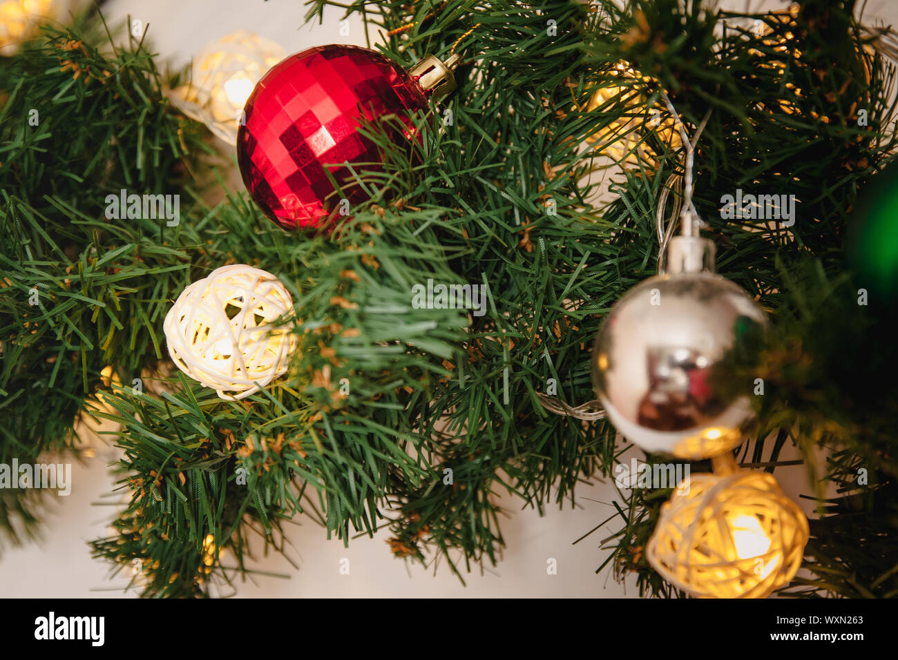 glass ball and decorations on Christmas tree. Garland with lights and ...
