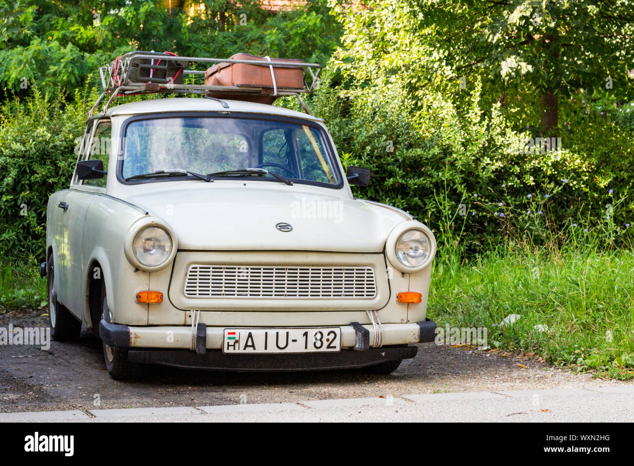 Trabant 601 limousine car parked with old-fashioned suitcases on roof rack, Sopron, Hungary Stock Photo