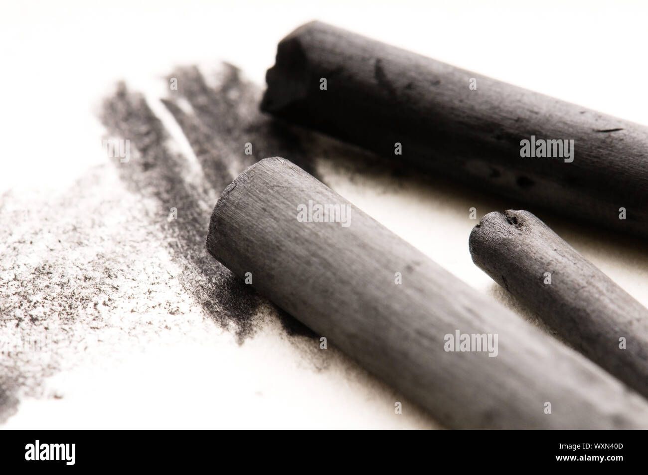 Artist's black charcoal with smudge Stock Photo - Alamy