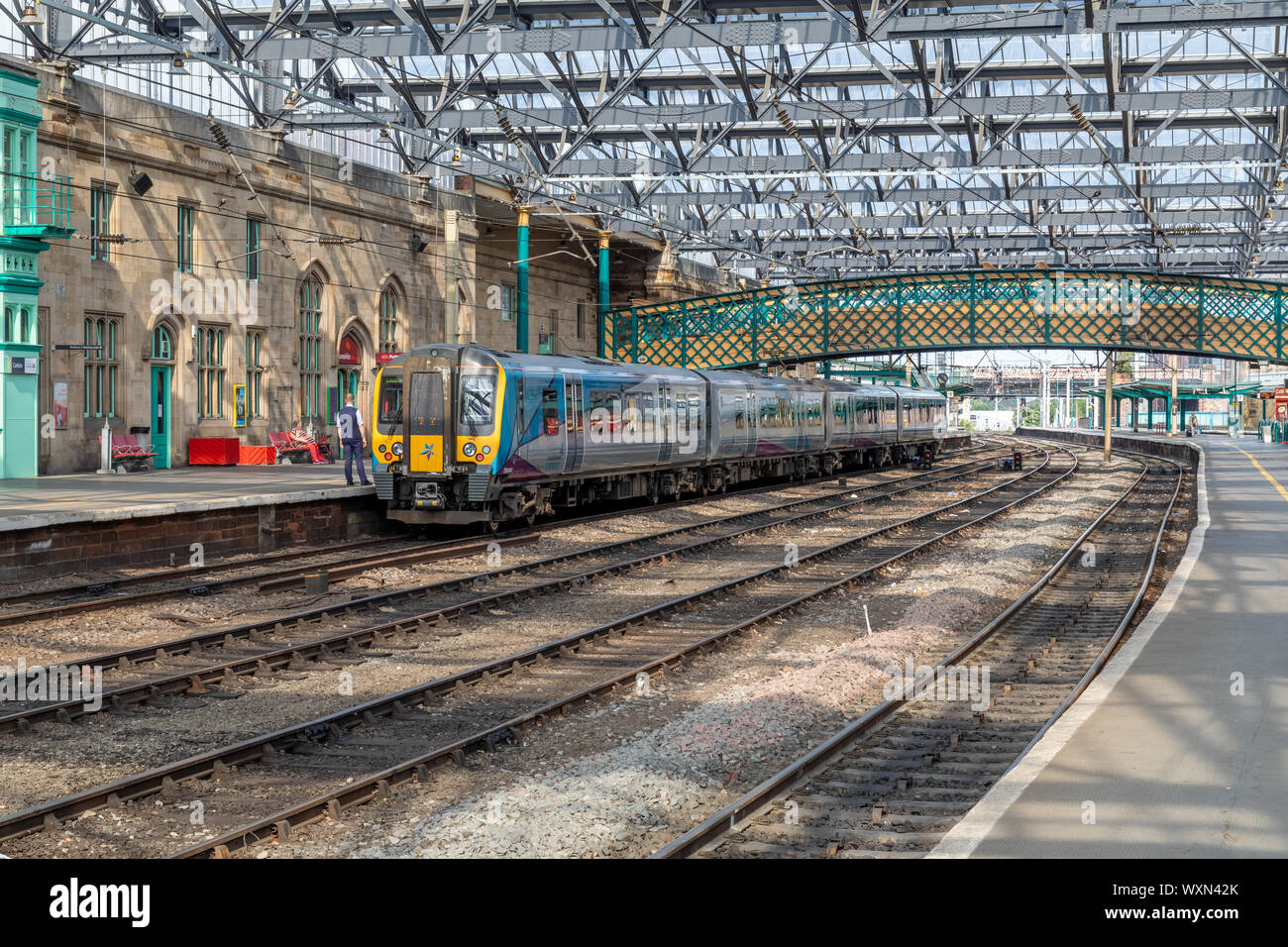 A Class 350 Transpennine Train sitting at platform 3 of the glass roofed Carlisle Station. This train is heading to Edinburgh Waverley station Stock Photo