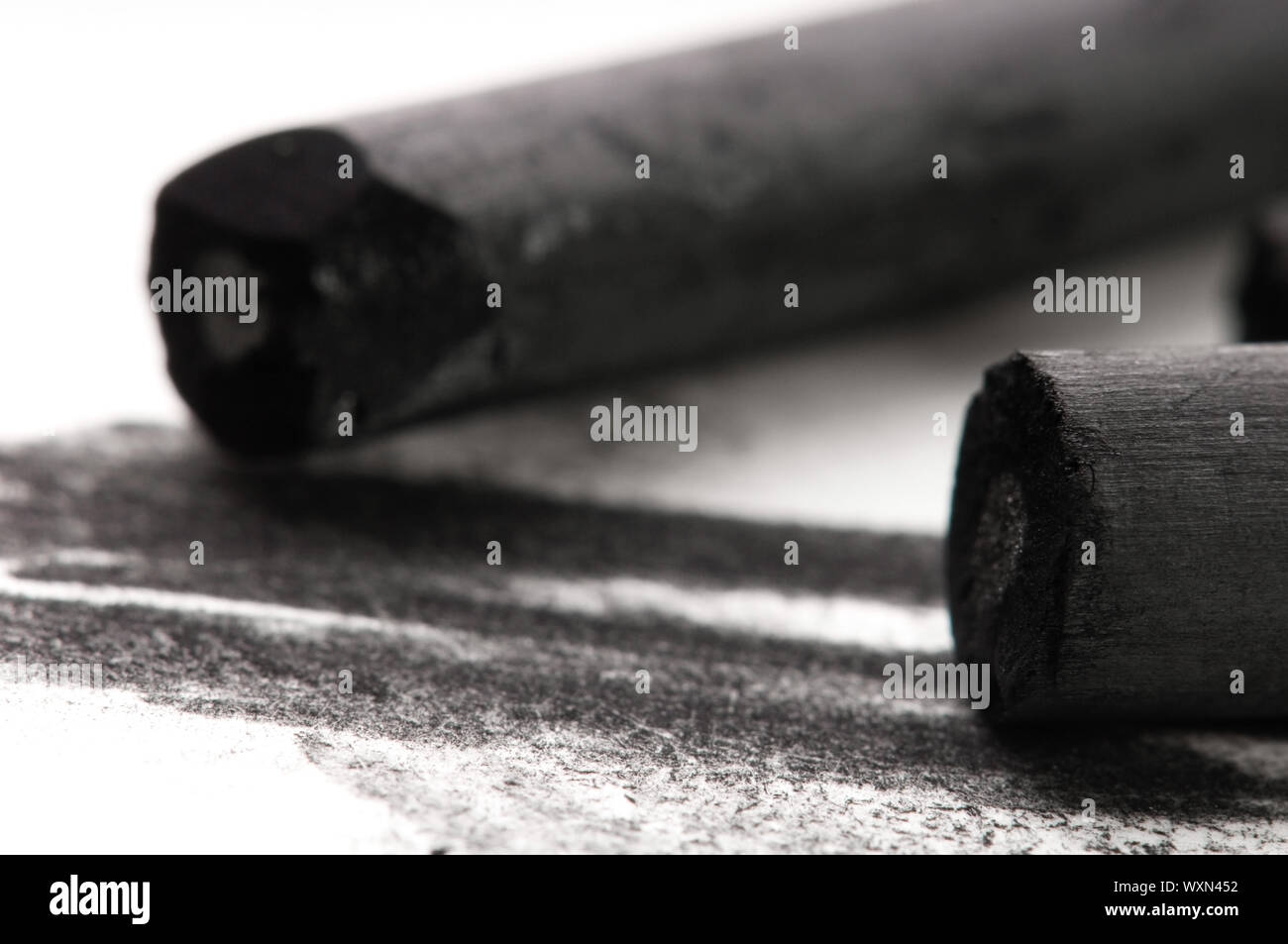 Artist's black charcoal with smudge Stock Photo - Alamy