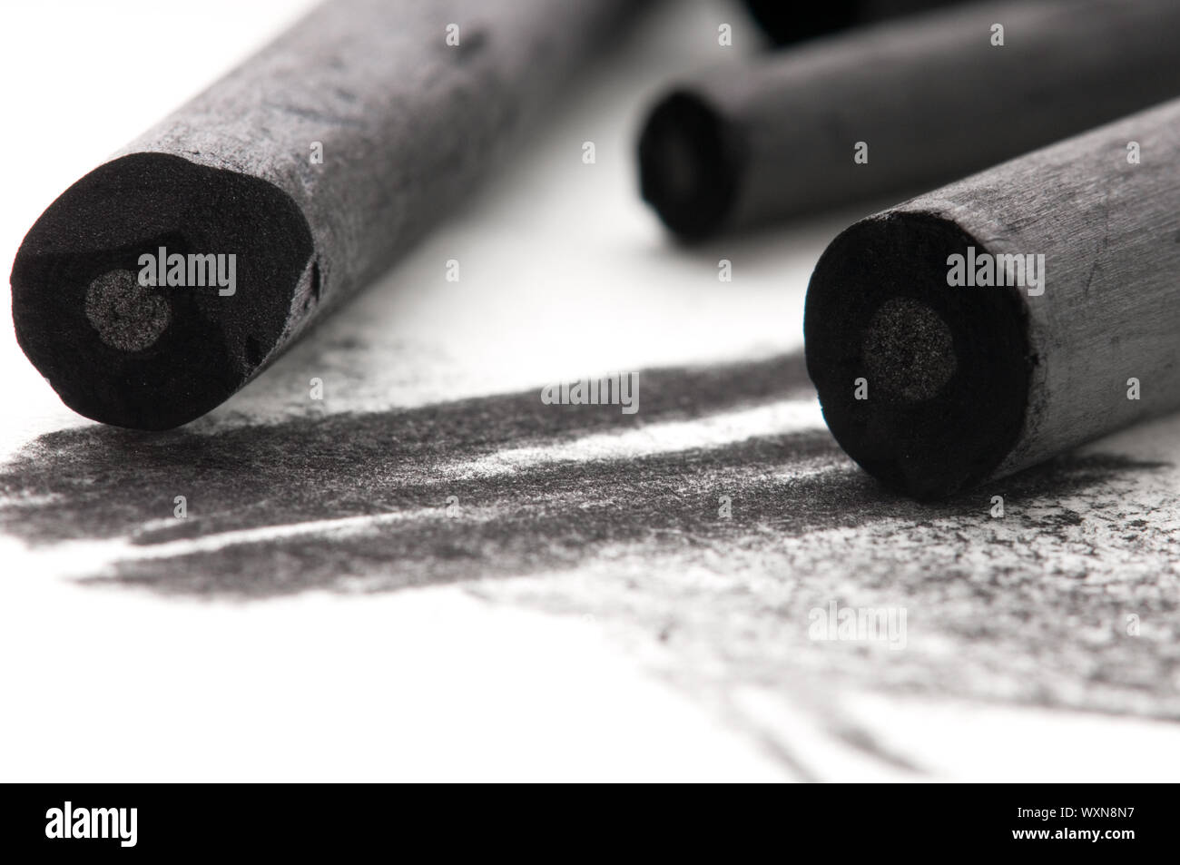 Artist's black charcoal with smudge Stock Photo - Alamy