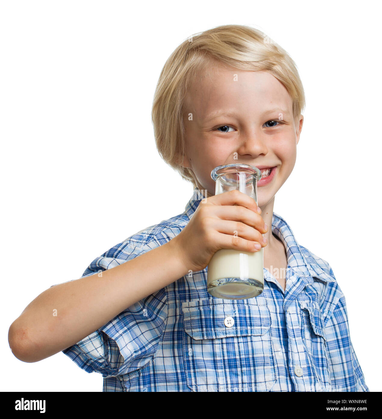 Smiling cute boy about to drink out of a bottle of milk. Isolated on white. Stock Photo