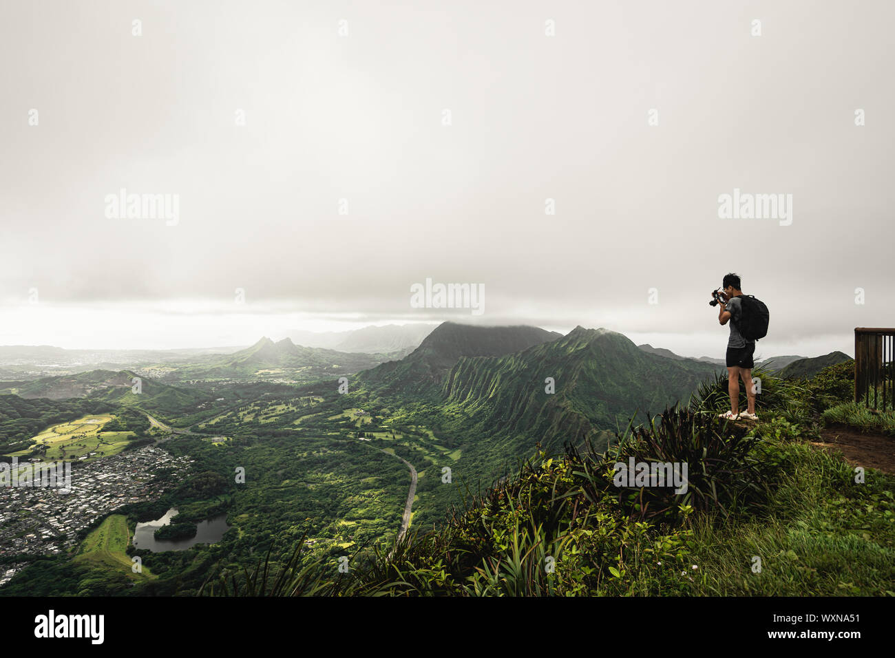 Kaneohe, Oahu - 25 AUGUST 2019: Guy takes photos at the top of the Stairway to Heaven (Haiku Stairs) hike. Oahu, Hawaii. Stock Photo