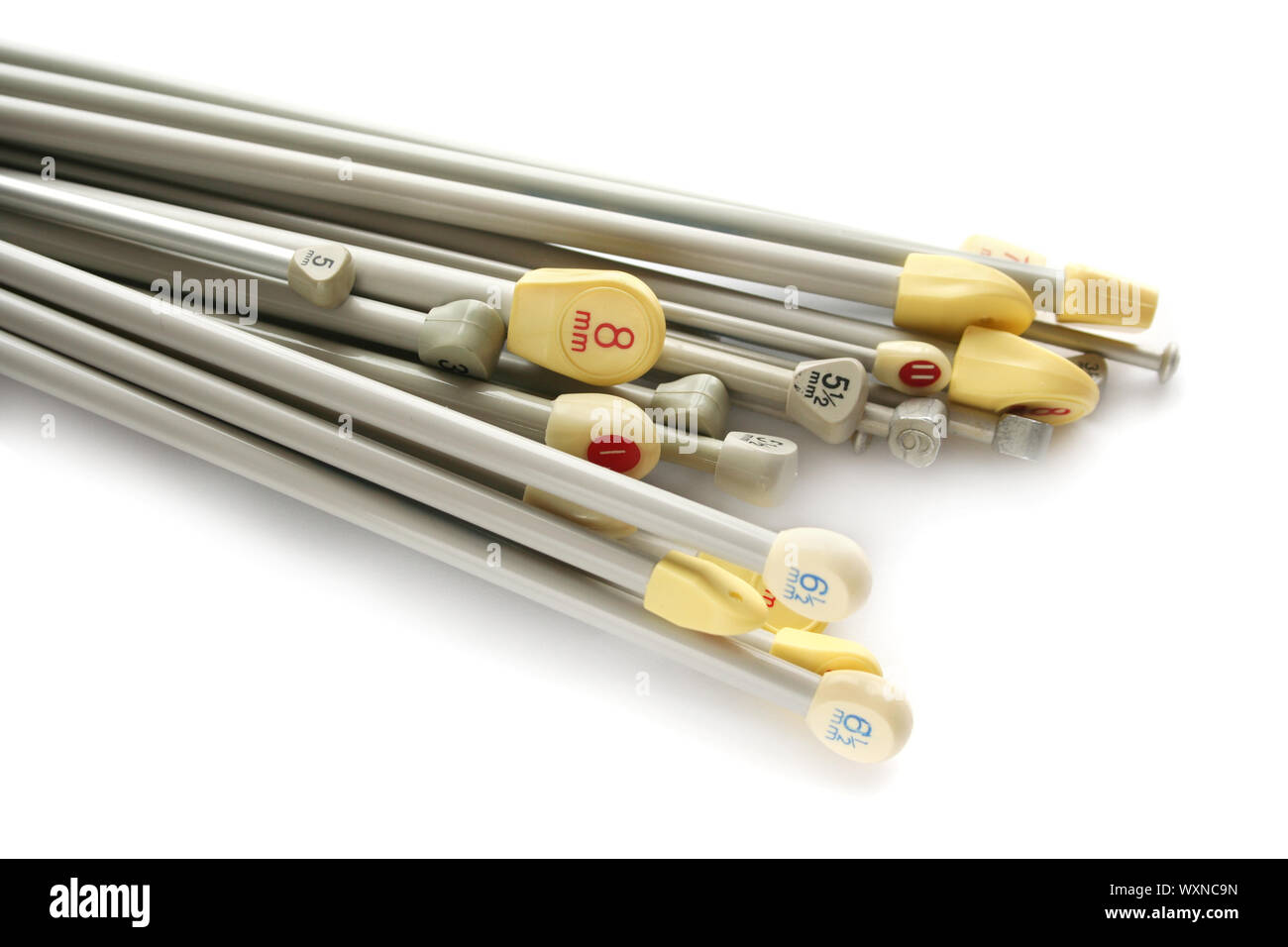 variety of knitting needles in different sizes both European