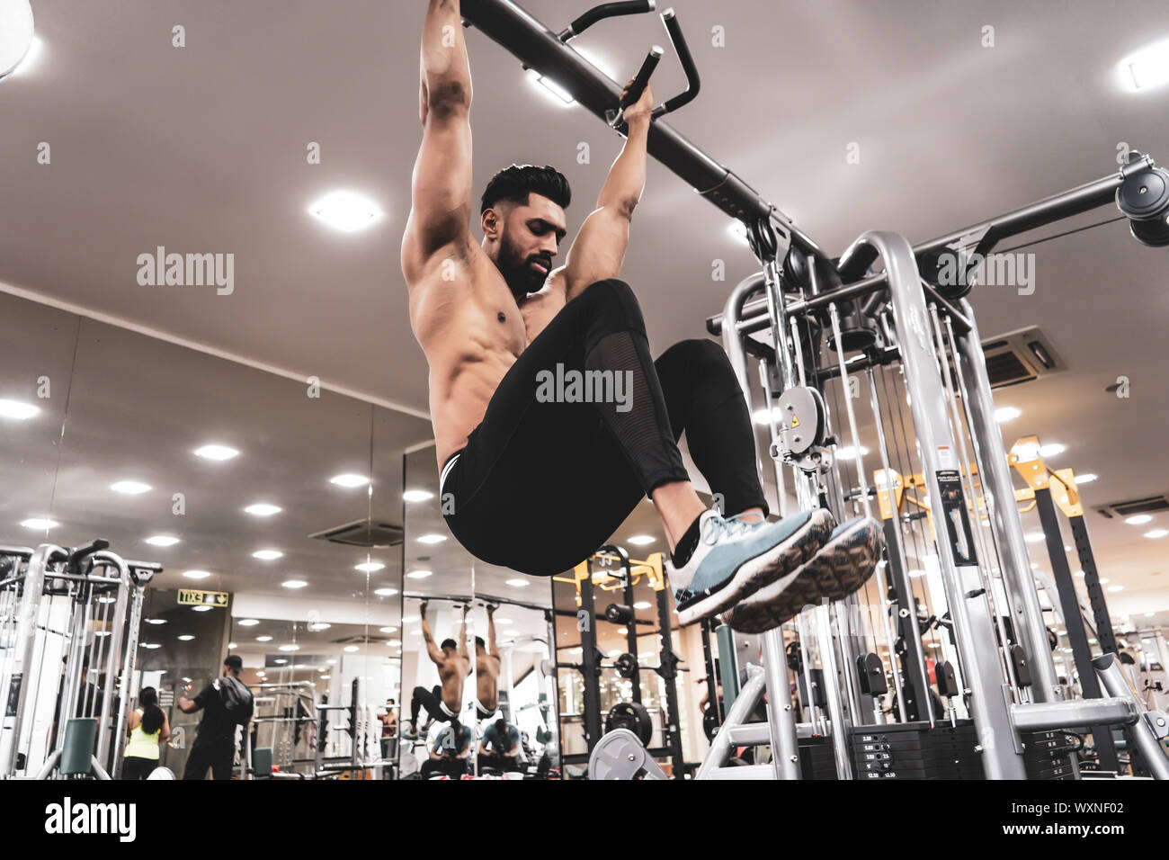 Man Athlete Doing Pull Ups - Chin-Ups In The Gym Stock Photo