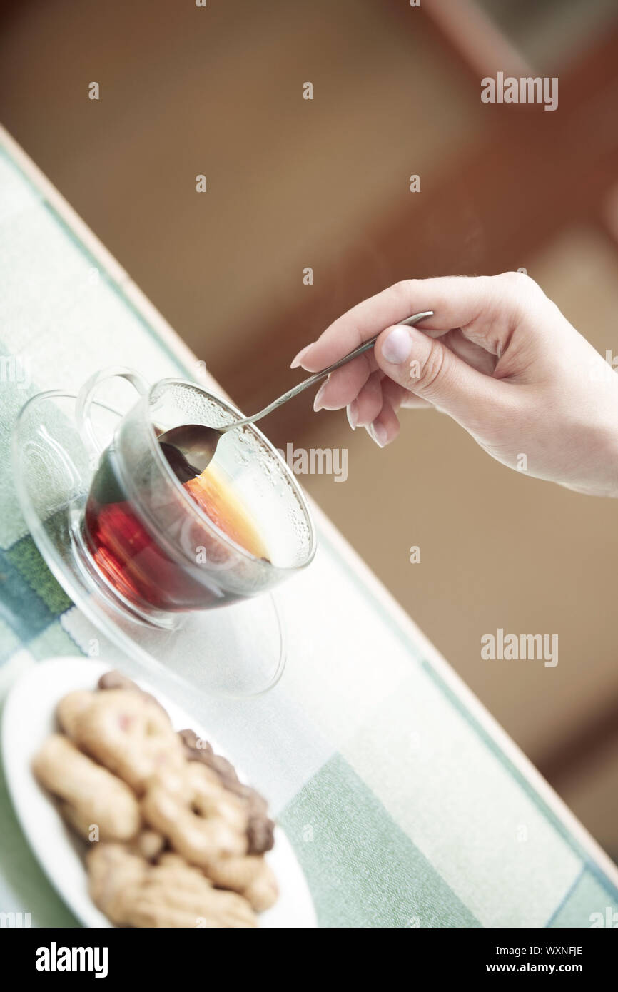 Human hands making tea Stock Photo - Alamy