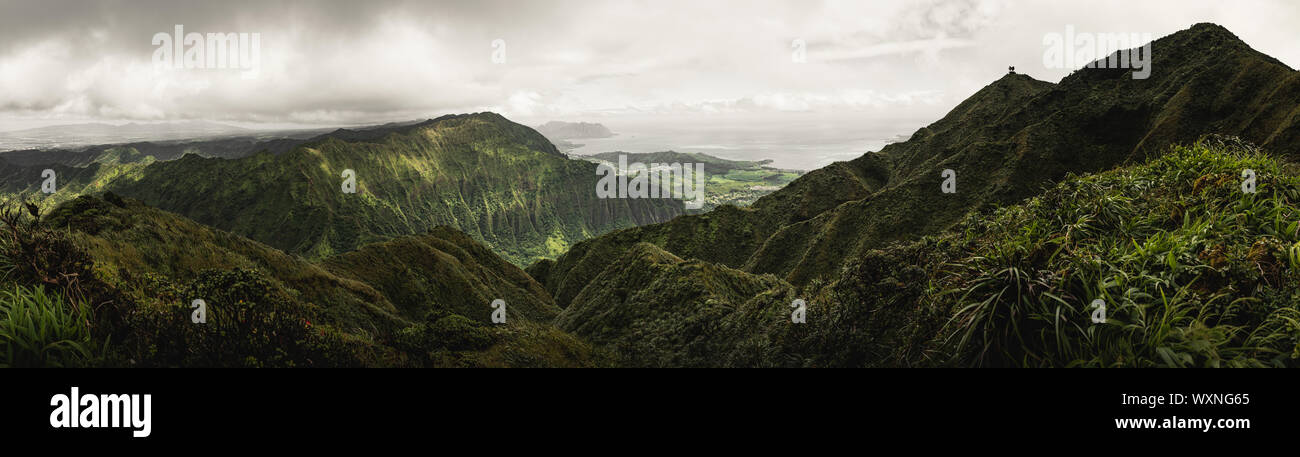 Morning panorama of the beautiful and rugged green mountains of Oahu on the Moanalua Valley Trail. Stock Photo