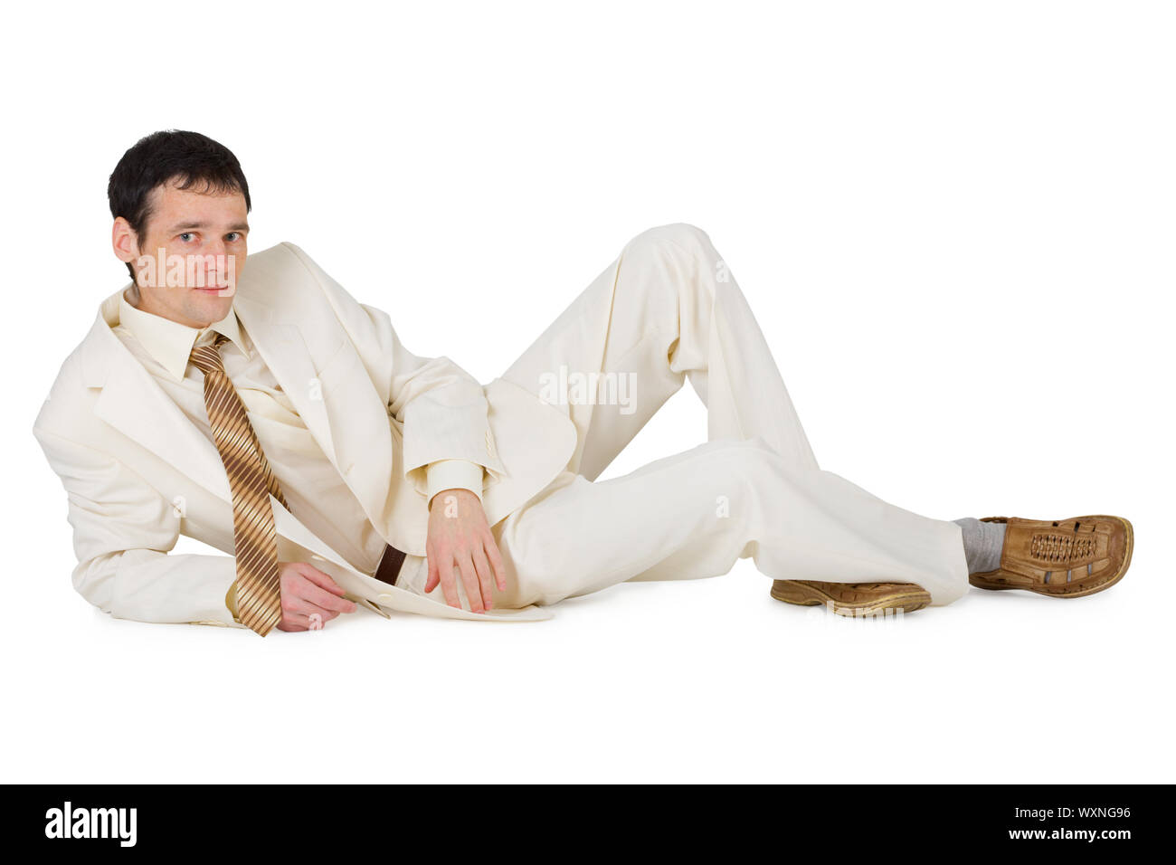 A handsome young man in a suit lying on a white background Stock Photo ...