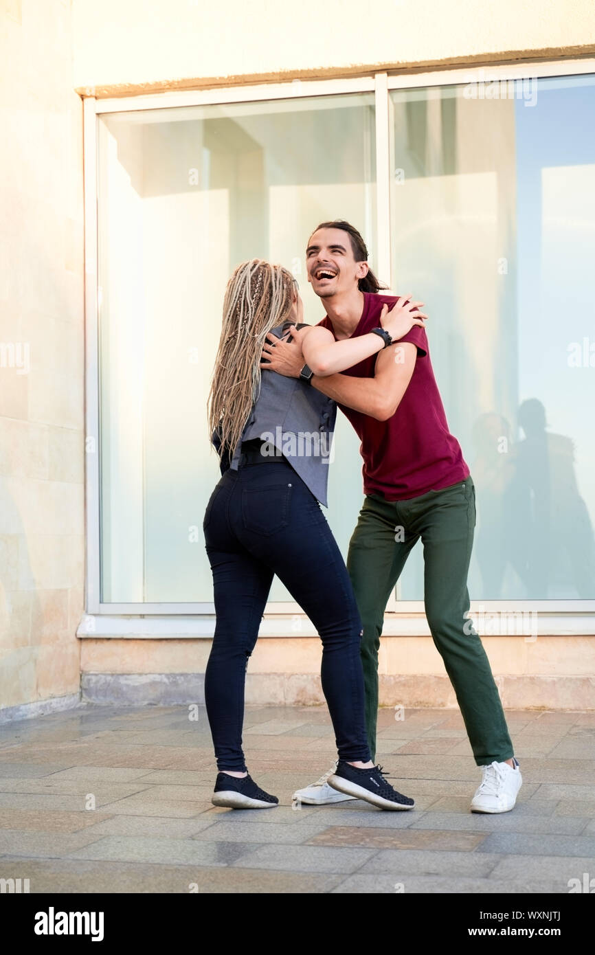 Young couple enjoying first date, dancing outdoors Stock Photo