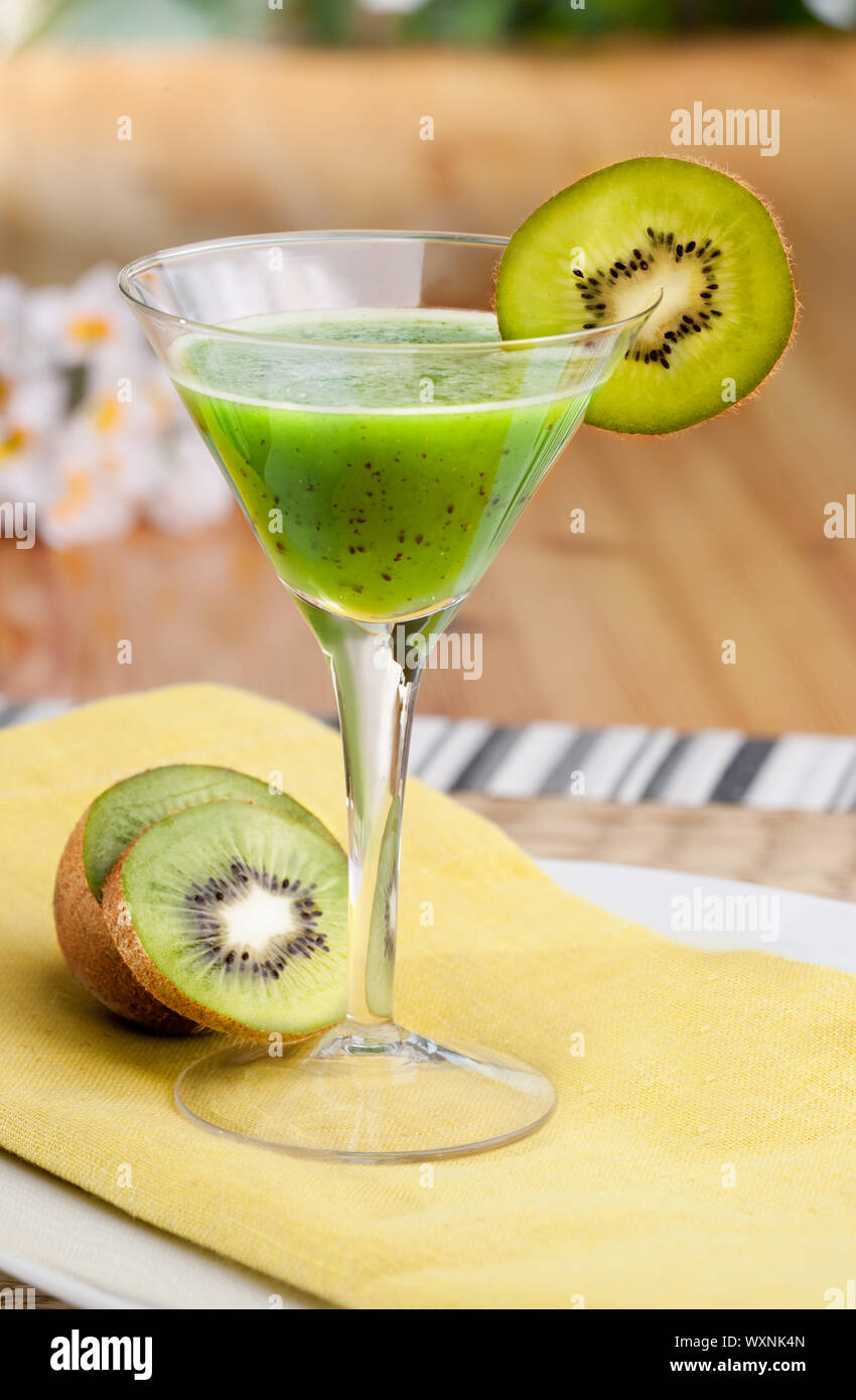 A kiwi based fruit drink in a martini glass Stock Photo Alamy