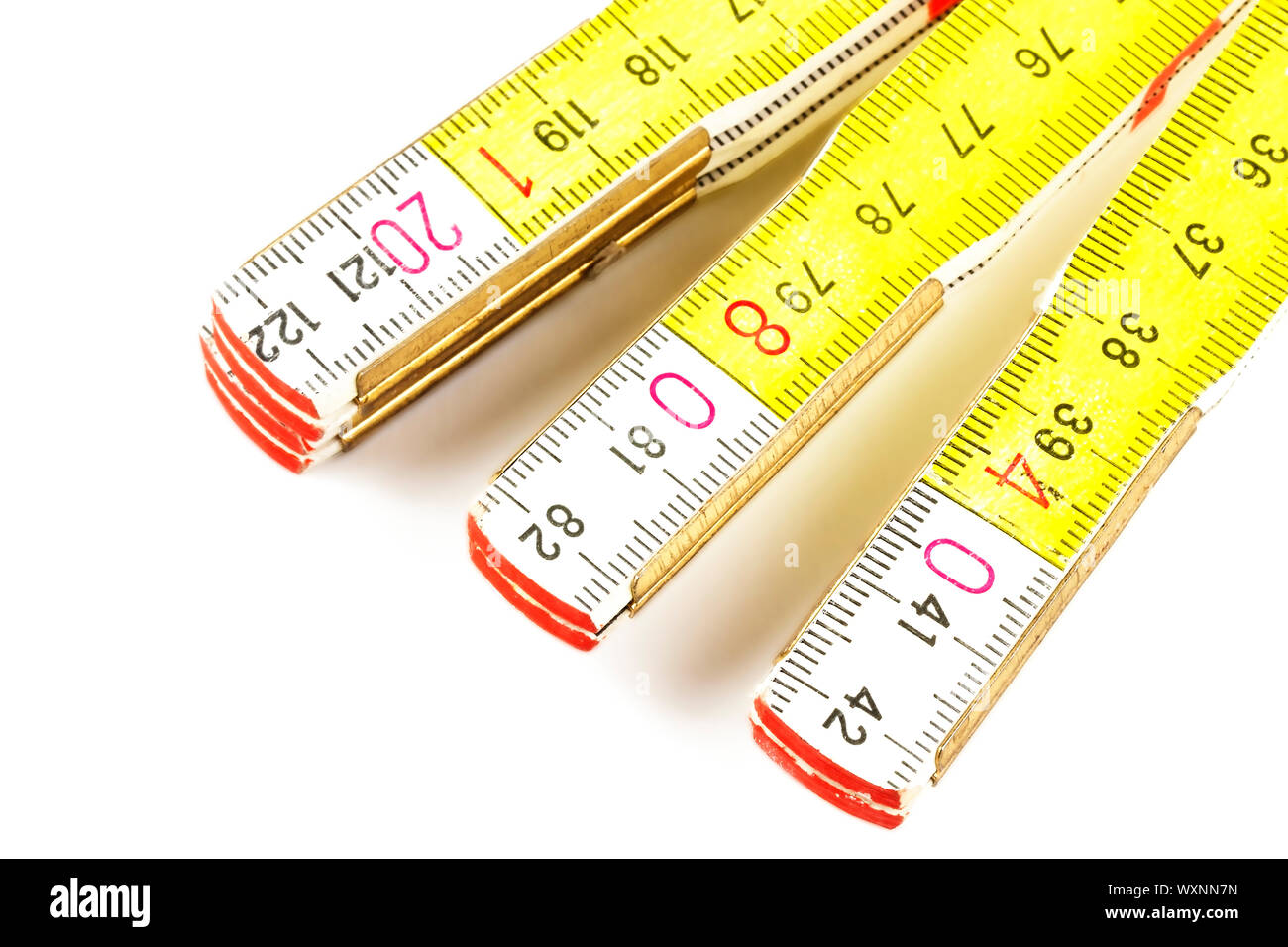 yellow folding rule isolated on white background Stock Photo - Alamy
