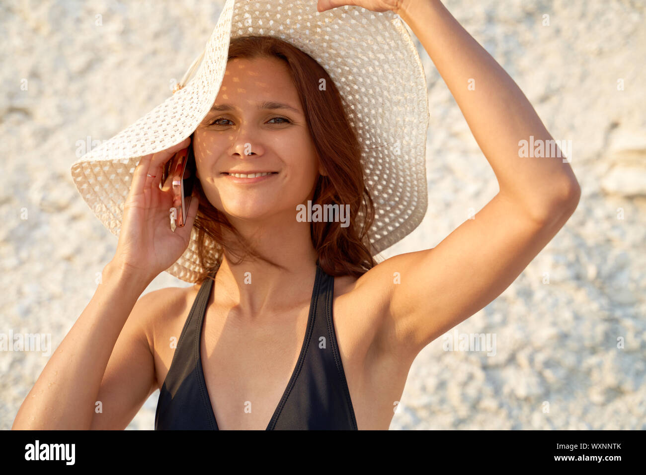 A Brunette Bikini Model With Small Breasts Posing On A Beach. Sexy Girl In  Bikini Posing At Sunset Against Blue Water Stock Photo, Picture and Royalty  Free Image. Image 31481794.