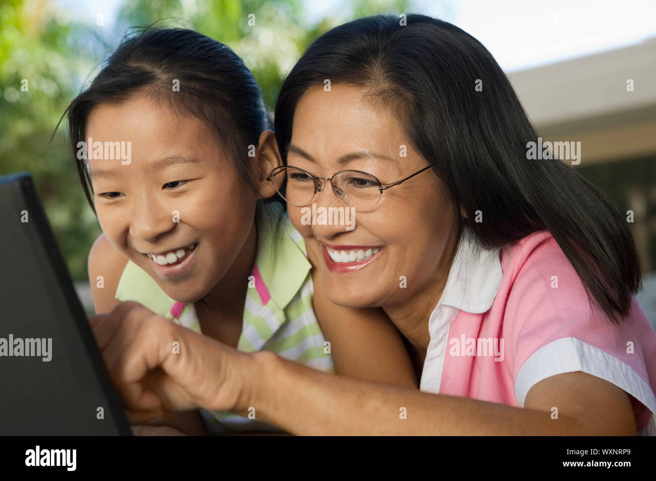 Mother and Daughter Using Laptop Together Stock Photo