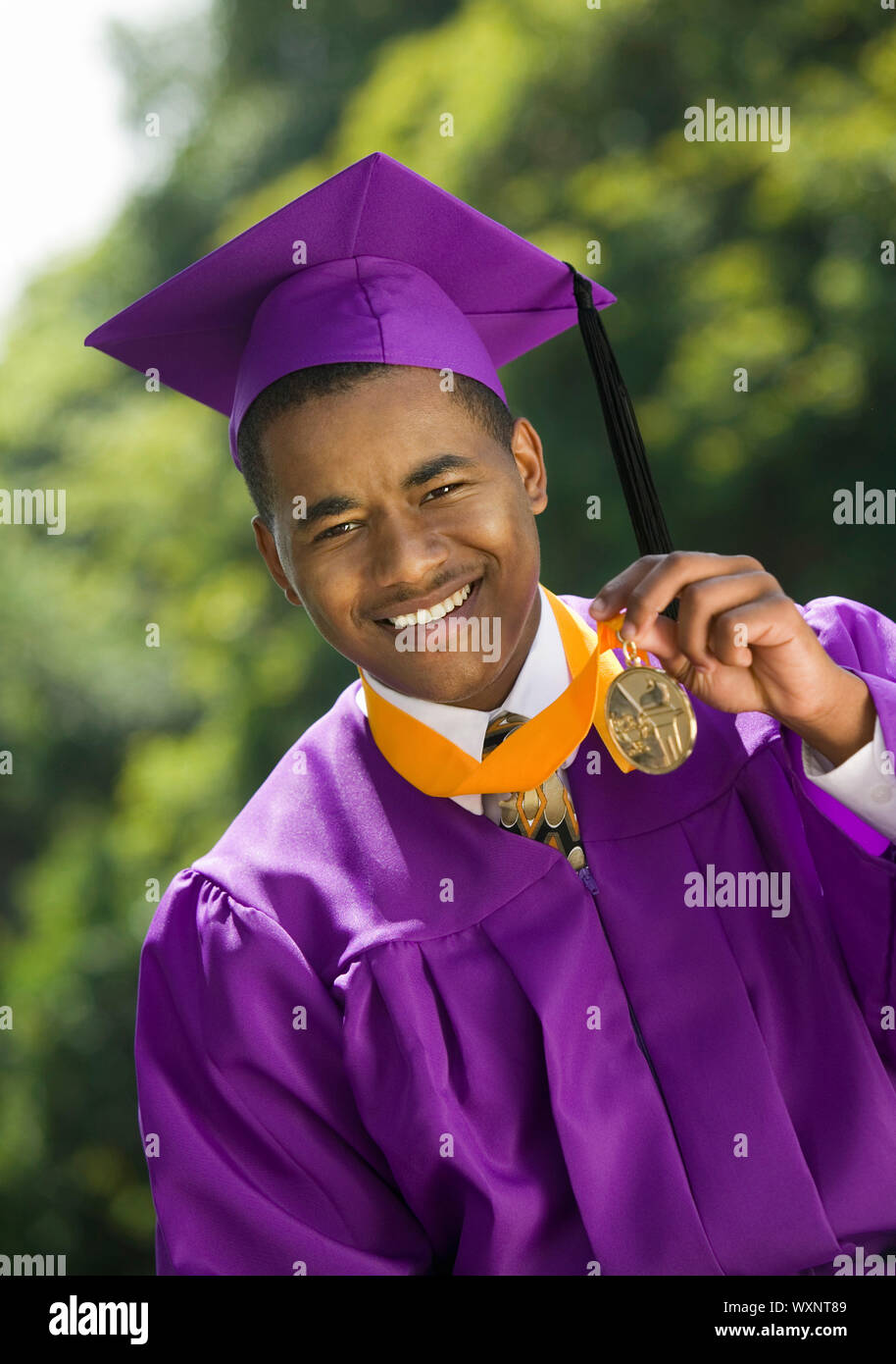 Graduate Holding Medal Stock Photo