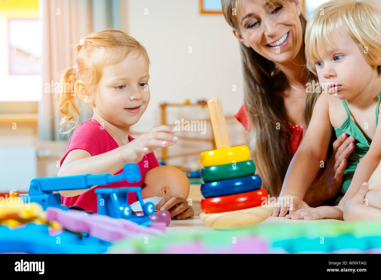 Children in nursery school learning and playing games Stock Photo