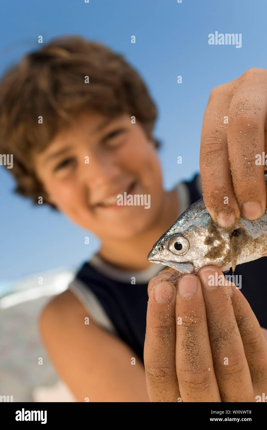 Boy Playing with Fish Stock Photo