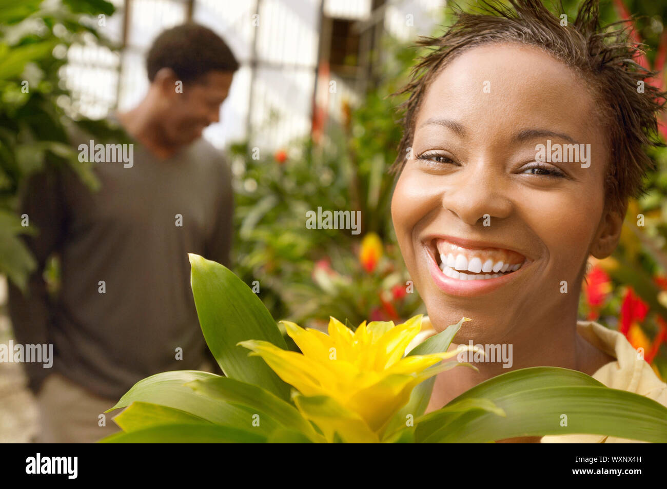 Smiling Woman in a Greenhouse Stock Photo - Alamy