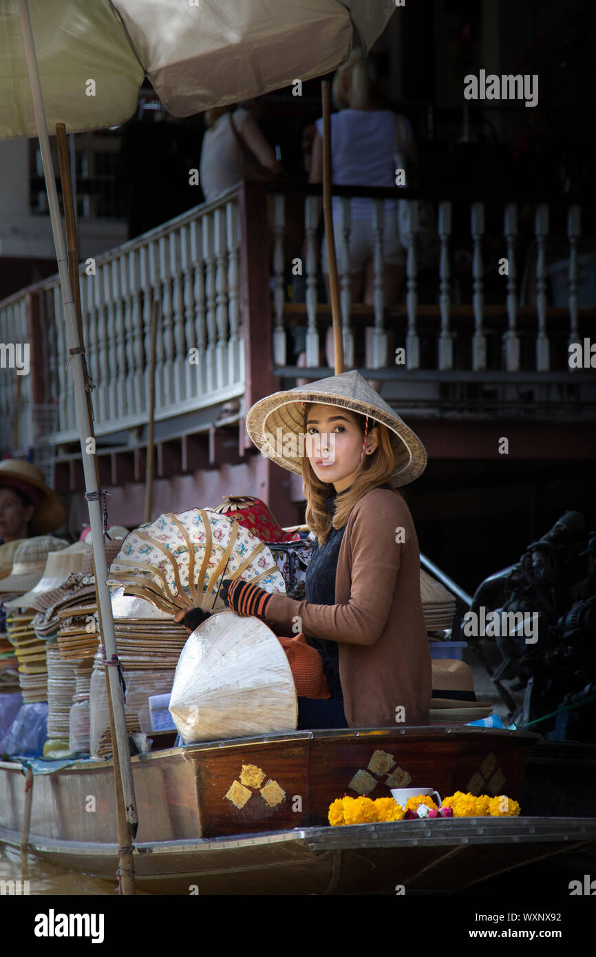 Asian girl selling authentic handicraft. Asian girl on floating market. Stock Photo
