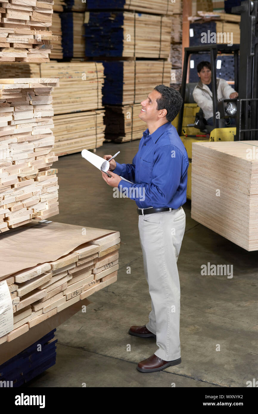 Manager in Lumber Warehouse Checking Inventory Stock Photo Alamy