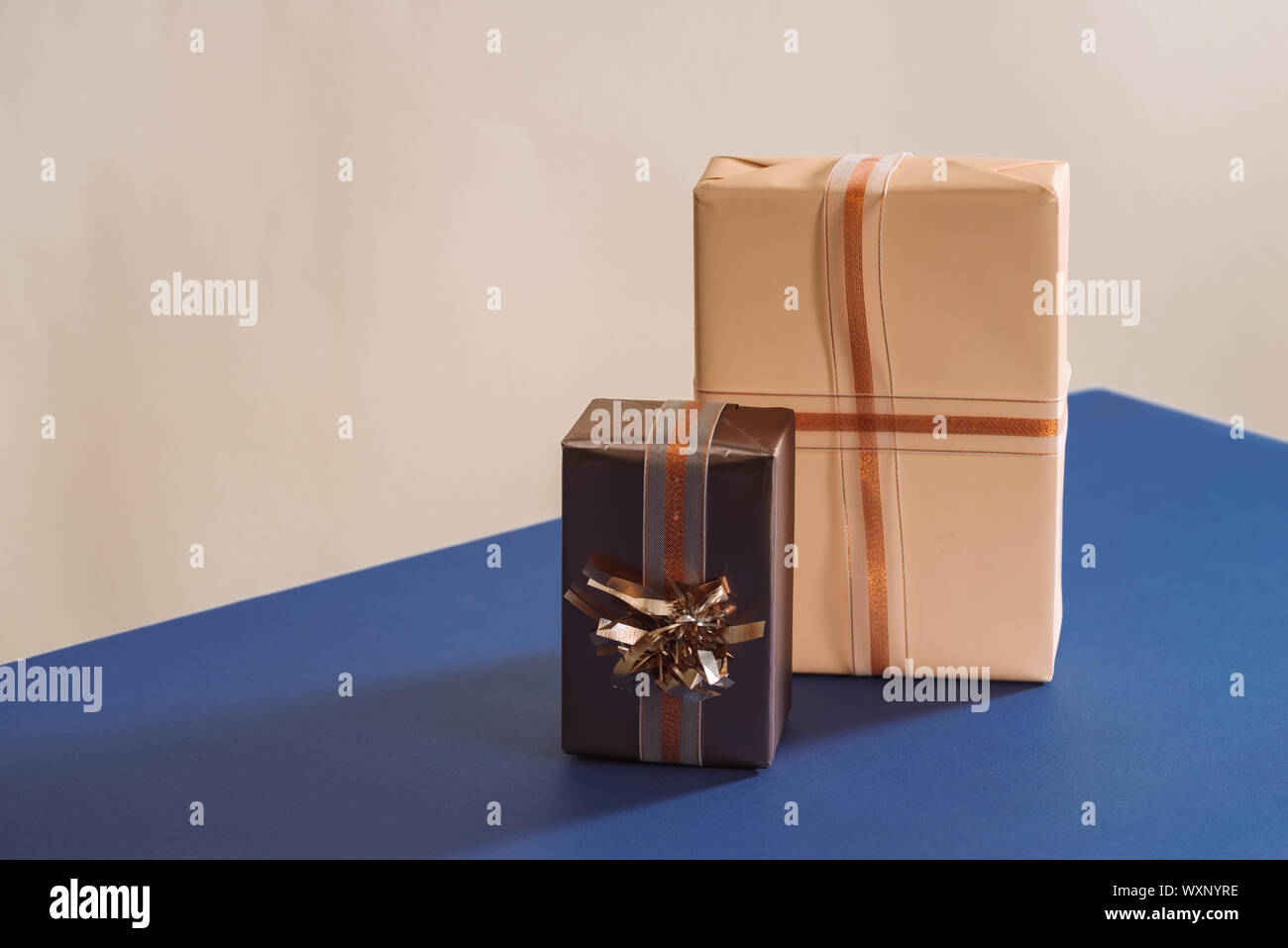 Two Ribbons Gift Two gifts boxes with ribbons on blue background Stock Photo - Alamy