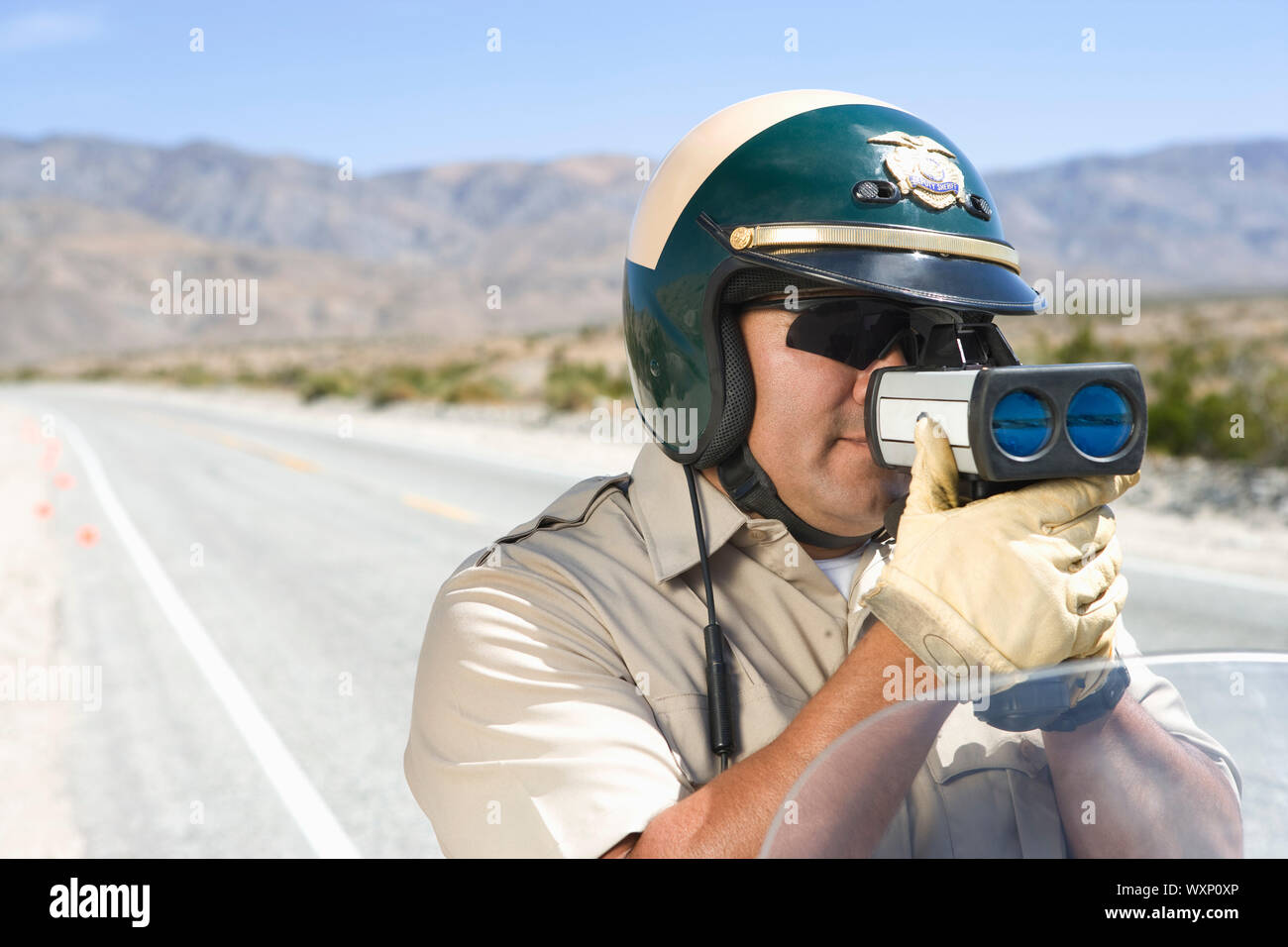 Police officer using speed gun Stock Photo Alamy