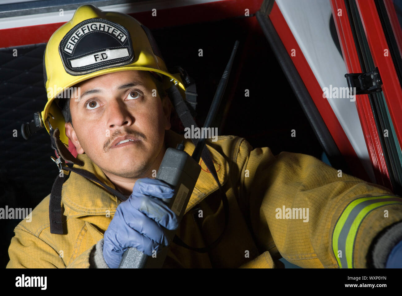 Firefighter using walkie talkie Stock Photo - Alamy