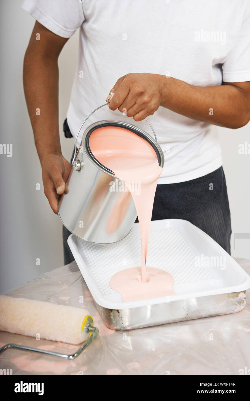 Man Pouring Paint Into Tray Stock Photo Alamy