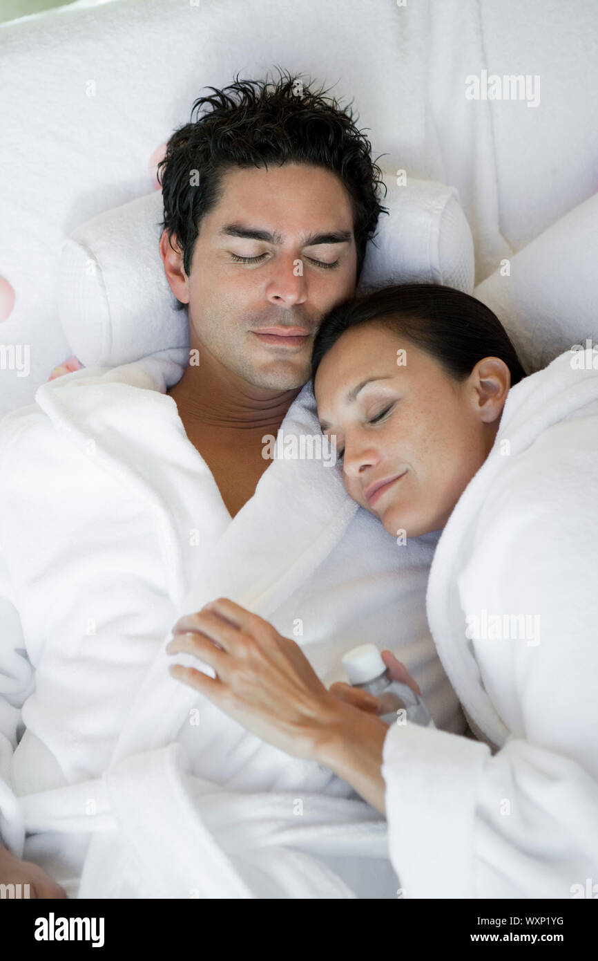 Couple sleeping in bathrobes Stock Photo Alamy