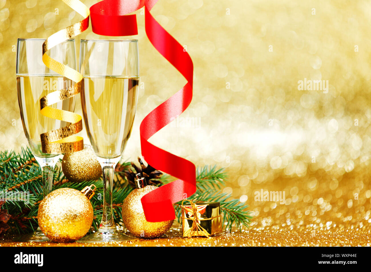 Champagne and new year decoration on golden background Stock Photo - Alamy