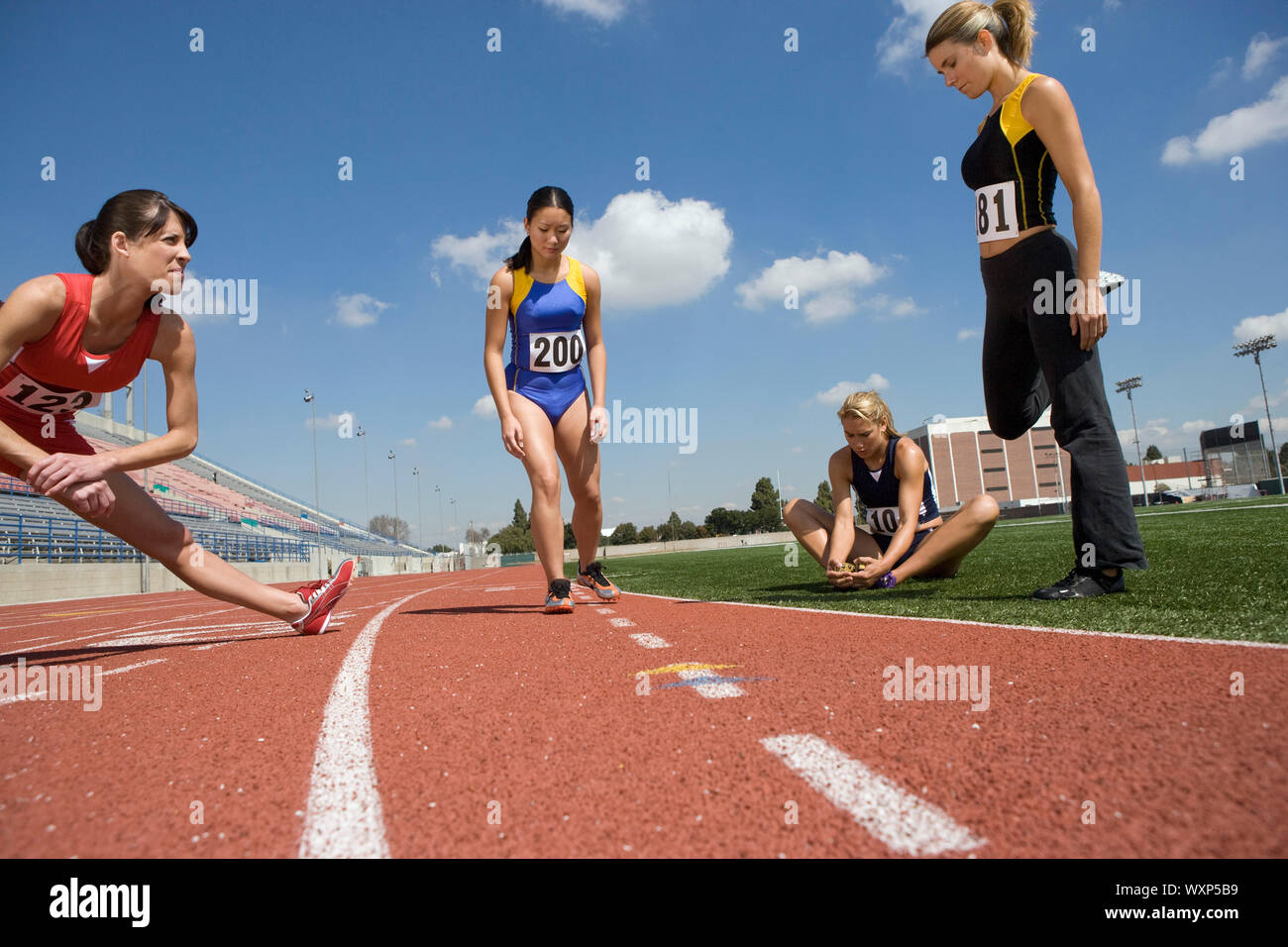 Female athletes warming up for run, low angle view Stock Photo - Alamy