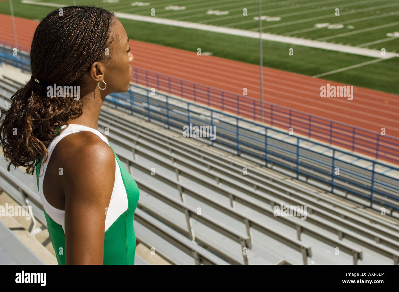 Female track athlete looking over stadium Stock Photo Alamy