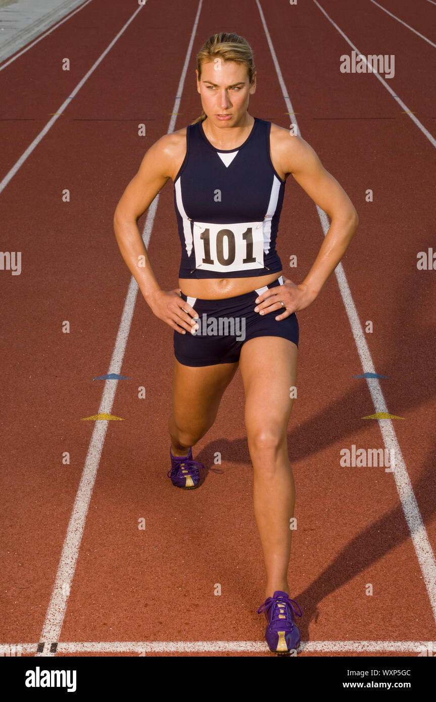 Female track athlete stretching Stock Photo Alamy