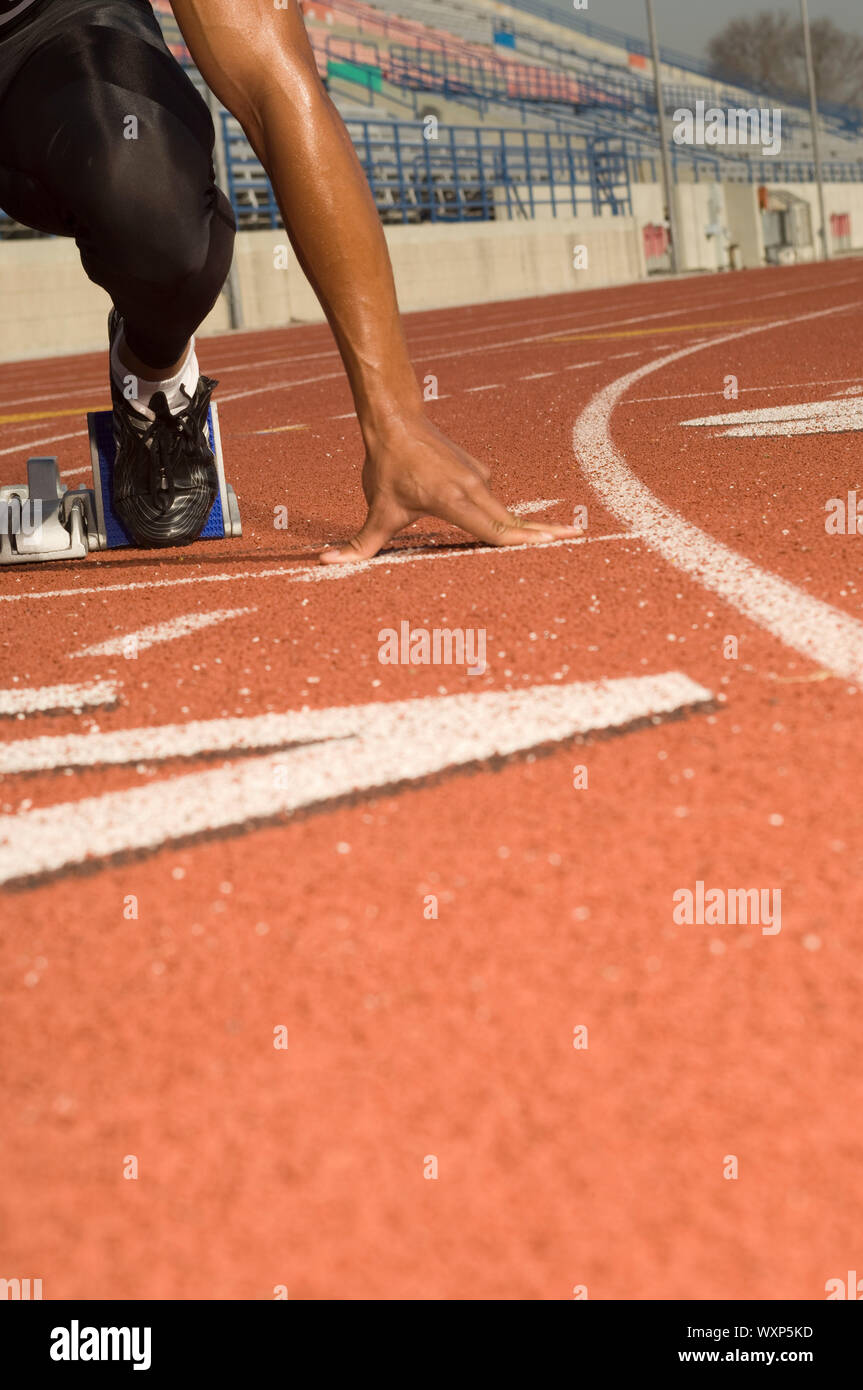 Male track athlete on starting block Stock Photo Alamy