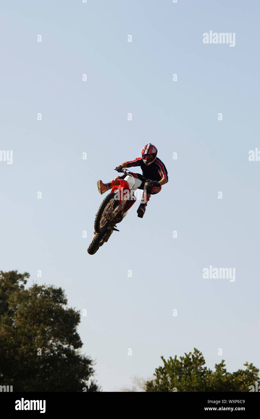 Freestyle Motocross Racer Performing Stunt Stock Photo