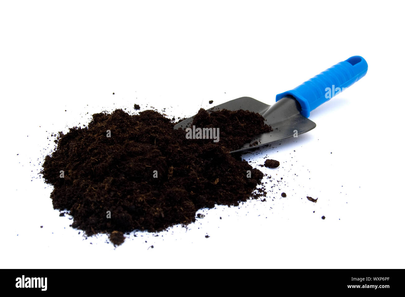 A gardening spade with potting compost on white Stock Photo