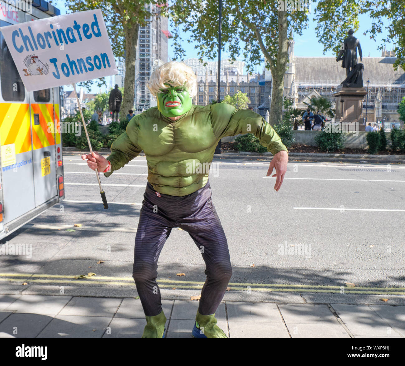 London, UK. 17th September 2019.  Demonstrator holding protest outside the Supreme Court, waiting for the ruling on the Legal challenge to the Prorogation of parliament. Pro defend democracy supporter in Hulk costume and Johnson wig holding silence protest, with sign  'Chlorinated Johnson' waiting for answer to challenge of legality of shut down  in wake of Brexit deadline . Credit: JF Pelletier/Alamy Live News. Stock Photo