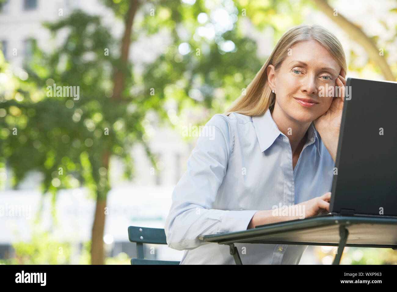 Portrait of a happy senior businesswoman using laptop Stock Photo