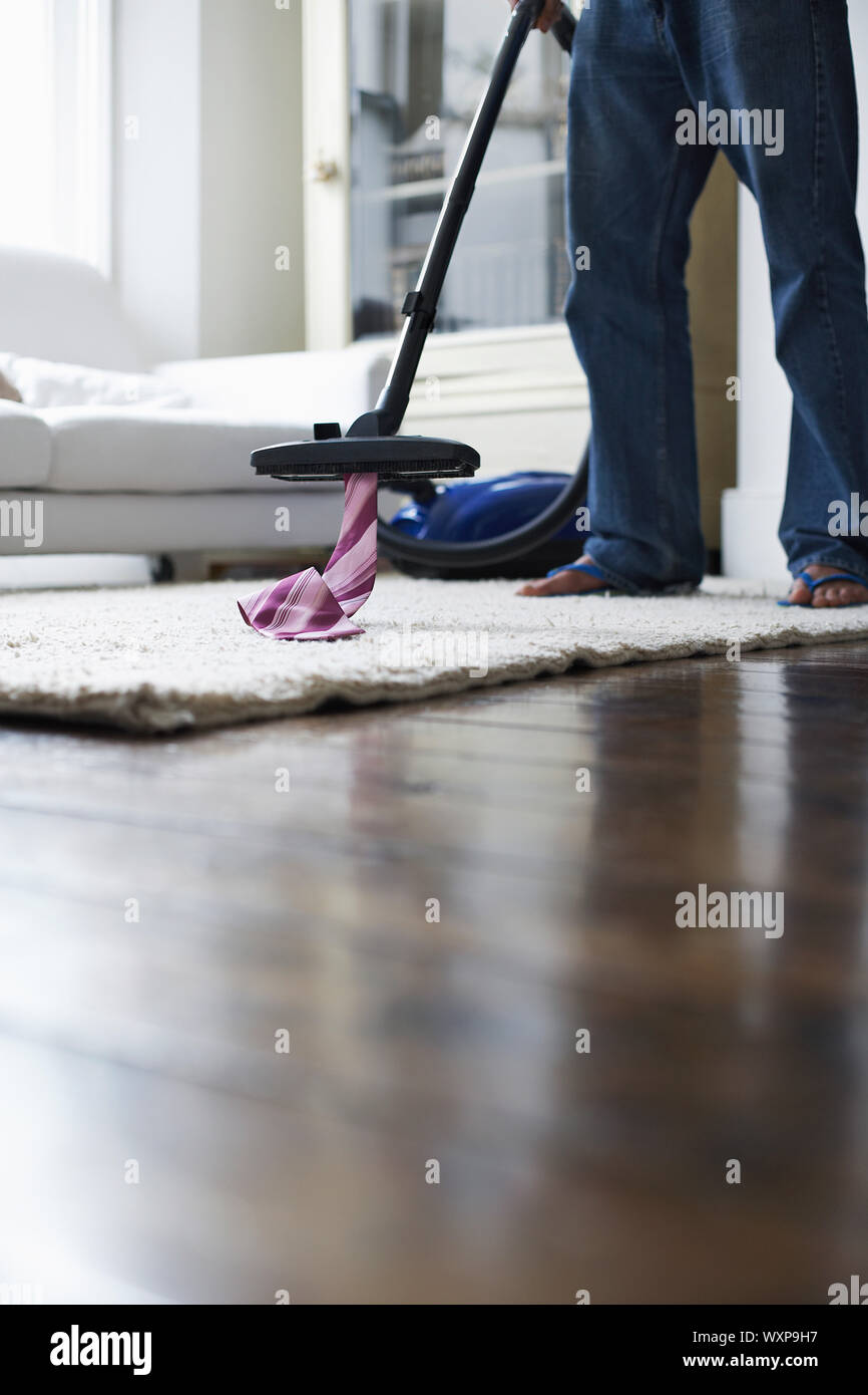 Low section of man cleaning house with vacuum cleaner Stock Photo